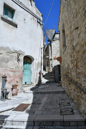 A narrow street among the old houses of Pietramontecorvino, a medieval village in the state of Puglia.の写真素材