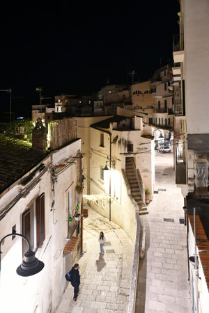 A narrow street among the old houses of a town in the province of Bari.の写真素材