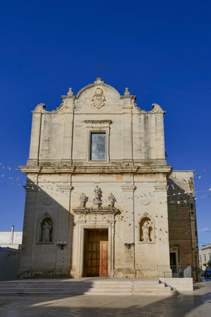 The facade of an ancient church in the medieval quarter of Muro Leccese, an old Apulian town.の写真素材