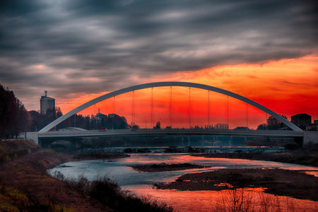 Alessandria architectural work on the Tanaro river in Alessandria. Sunset