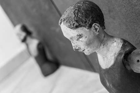 A little sad statues in black and white.
