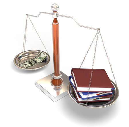 Money and books on balance scaleの写真素材