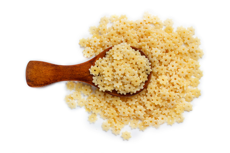 Pasta in wooden spoon isolated on white. Top view.の写真素材