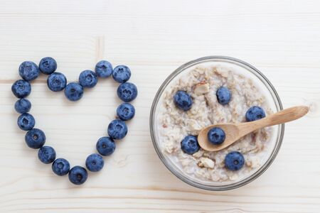 Tomorrow is blueberries and oat flakes. The symbol of the heart is laid out of blueberries.の写真素材