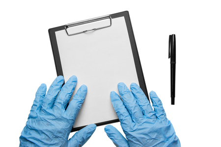 Hands in blue gloves lie on a clipboard on a whiteの写真素材
