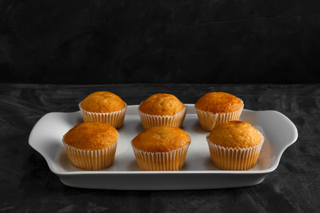 Cupcakes on a white plate on a darkの写真素材