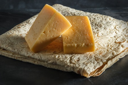 Two pieces of cheese in Armenian pita breadの写真素材