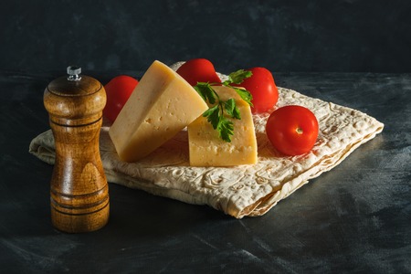 Two pieces of cheese, parsley and tomatoes, in Armenian pitaの写真素材