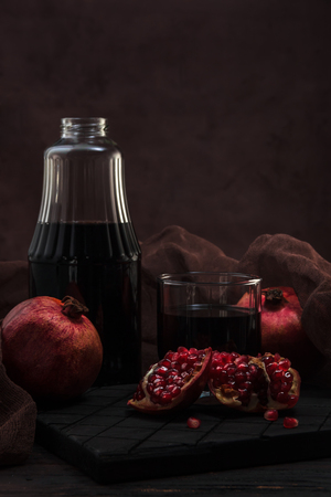 Pomegranate juice in a bottle and glassの写真素材