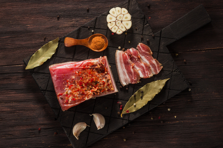 Salted dried bacon with spices and bay leaves and garlicの写真素材