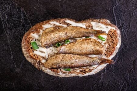 Sandwich with sprots on rye bread lies on a concrete backgroundの写真素材