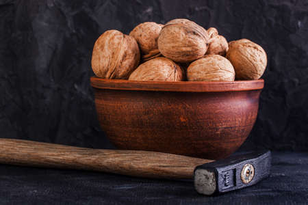 Walnut and hammer in potteryの写真素材