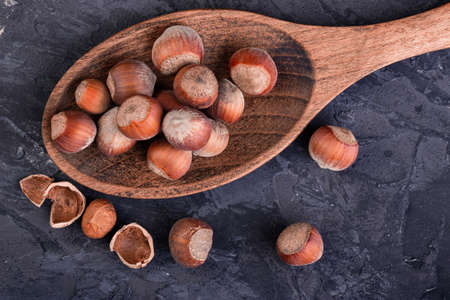 Hazelnuts in a spoon and one broken nut