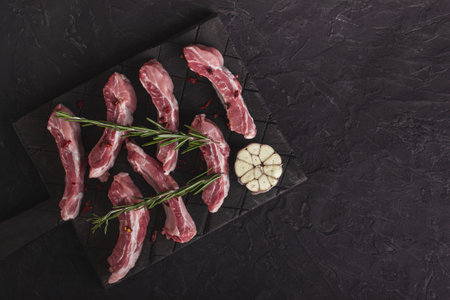 Raw chopped pork ribs with rosemary and garlicの写真素材