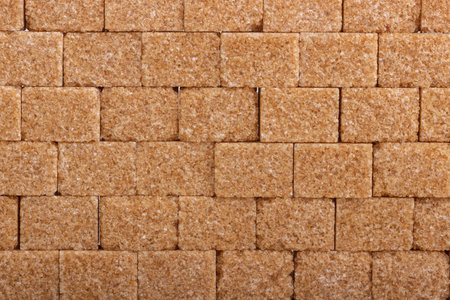Background of cubes of cane brown sugarの写真素材