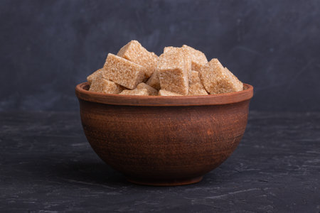 Cubes of cane sugar in a clay bowlの写真素材
