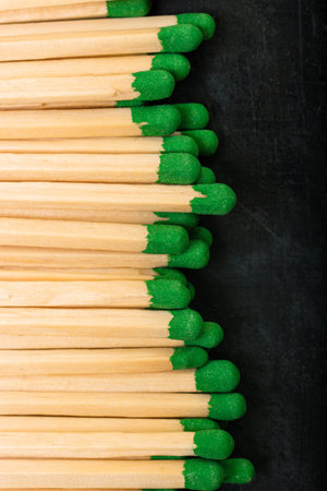 Long wooden matches with green gray laid out in a rowの写真素材