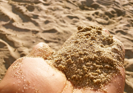 Beach sand in the hand, Mediteranean beach in Greeceの写真素材