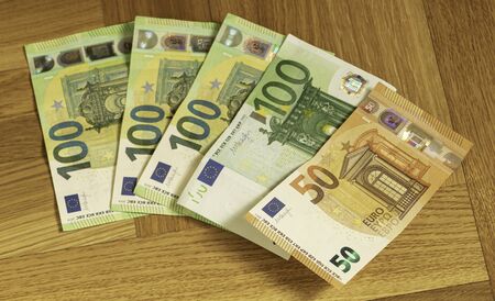 Currency in euro on a wooden background. Finance concept.