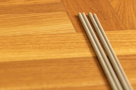 Electrodes for electric welding on wooden background.