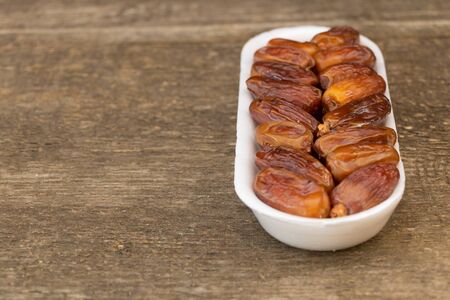 Benefits of Dates. Dried Dates on wooden background.の写真素材