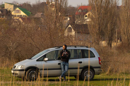 Danceni, Moldova - March 29, 2020. A young man next to his car went out into nature in the springのeditorial素材