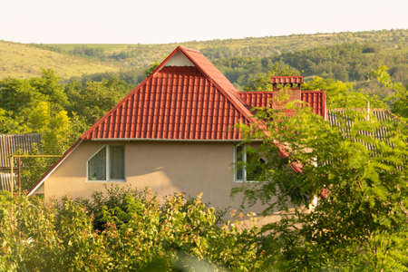 A beautiful house in the village, trees around itの写真素材