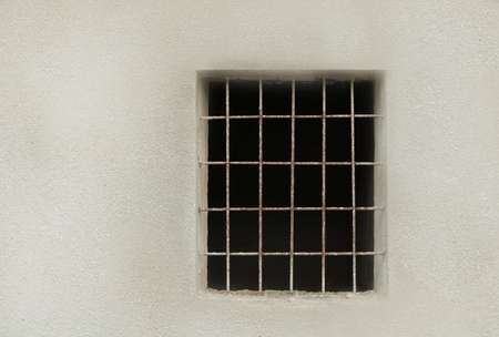 Window with bars to an abandoned house.
