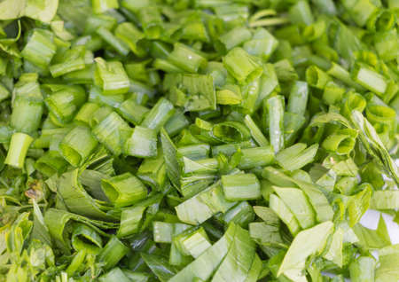 Sliced green onion texture background - recipe concept- in the process of cooking.
