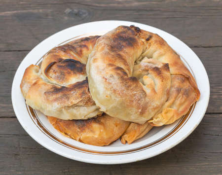 Delicious pies in a plate freshly cooked - Wooden Backgroundの写真素材
