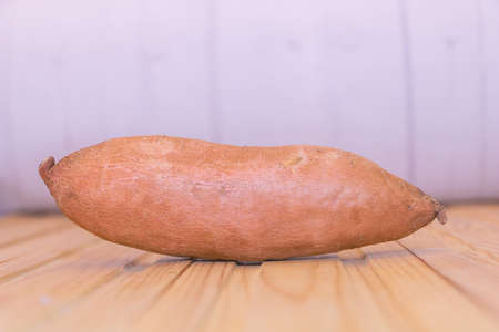 Close up shot of one fresh sweet potato - Benefits of sweet potatoes concept.の写真素材