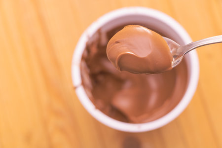 Selective focus shot of sweet cocoa cream in a teaspoon.の写真素材