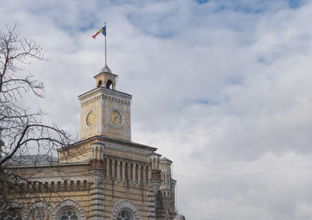 Chisinau City Hall surrounded by bare trees under a cloudy sky in Moldova.の写真素材