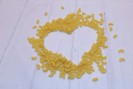 Closeup shot of dried pasta in the shape of a heart.の写真素材