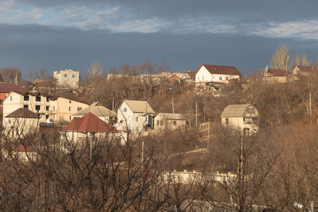 View of a village houses under a dark stormy sky.