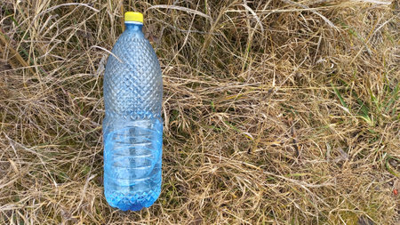 Plastic bottle on the grass. Pollution of the environment.の写真素材