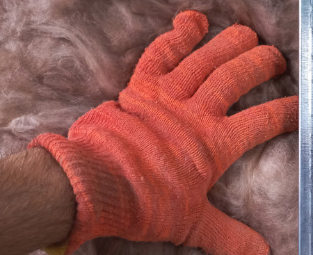 Protecting Your Home: Applying Mineral Wool Insulation by Hand.の写真素材