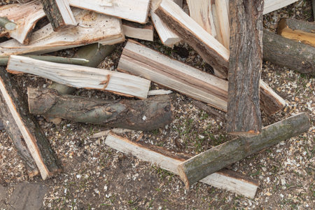 Pile of chopped firewood prepared for winter in the garden.の写真素材