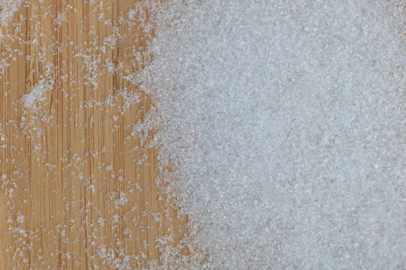 White sugar on wooden background. Top view. Selective focus.の写真素材