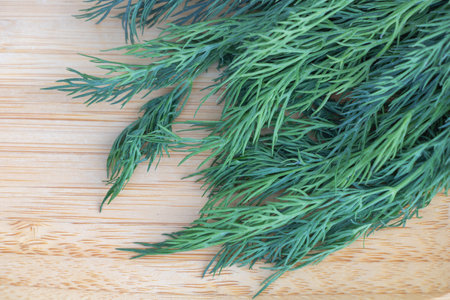 Fresh dill on wooden background. Selective focus. Shallow depth of field.の写真素材