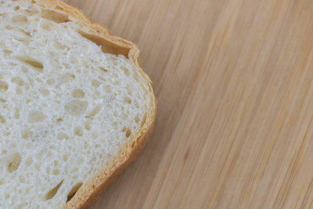 Sliced white bread on wooden board background. Copy space.の写真素材