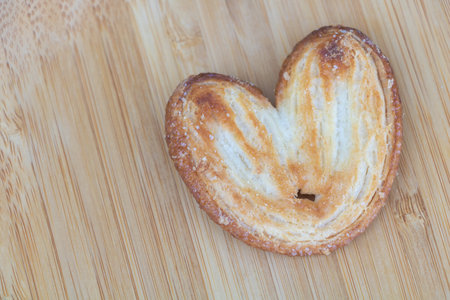 Heart shaped cookie on wooden background. Top view. Copy space.の写真素材