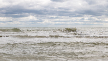 Adriatic sea shore under cloudy sky, waves and water splashesの写真素材