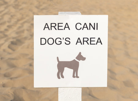 A sign warning about a dog on the beach in Rimini, Italy.の写真素材