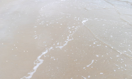 Sea wave on sand beach, closeup of photo. Natural background.の写真素材