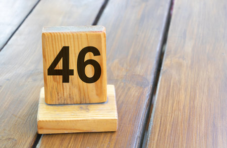 Wooden priority number 46 on a plank tab.