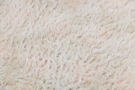 A close-up shot of the plush texture on white fluffy carpet, showcasing its softness and qualityの写真素材