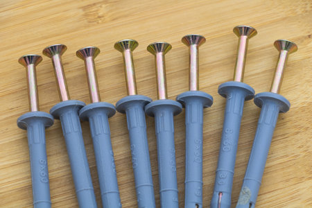 Wall-mounted box fastening nails, in a blue-gray color with brass heads