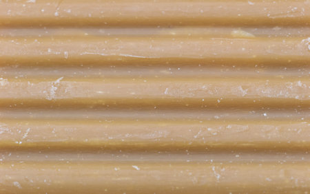 Textured Beige Surface with Horizontal Ridges and Subtle Specks.