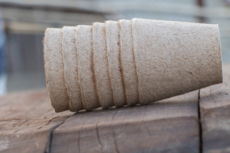 Close-up of the edge of an old wooden peat pot, with several stripes made from burlap fabric and cloth strips.の写真素材